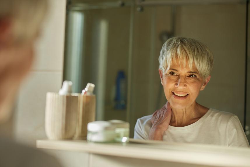 Woman smiling at herself in a mirror