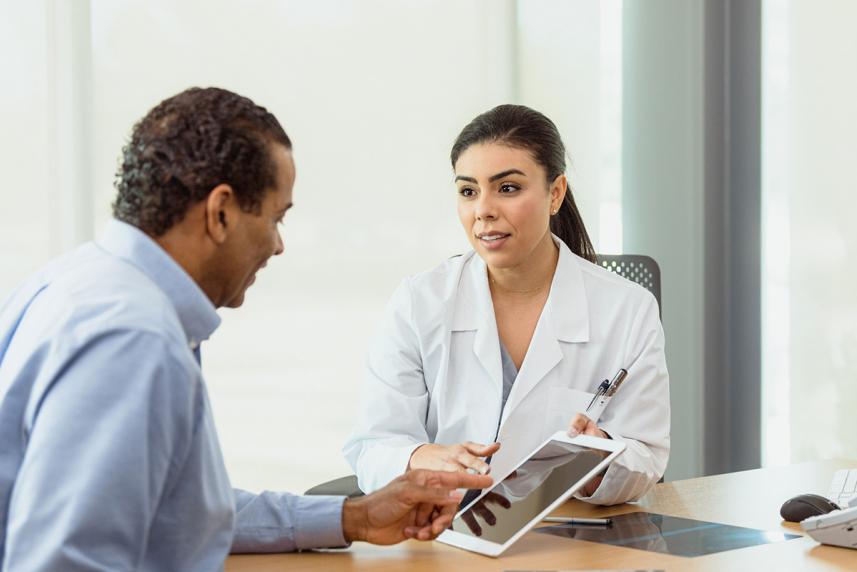 Doctor showing patient something on a tablet screen