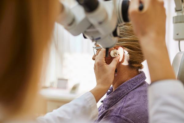 Doctor checking patients ear